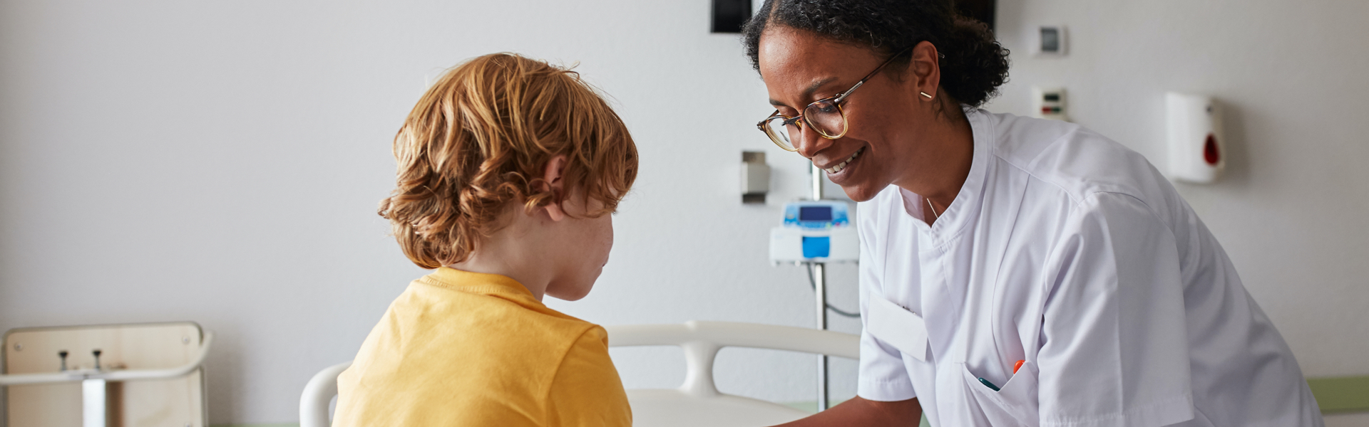 A young child is being helped by a health professional.