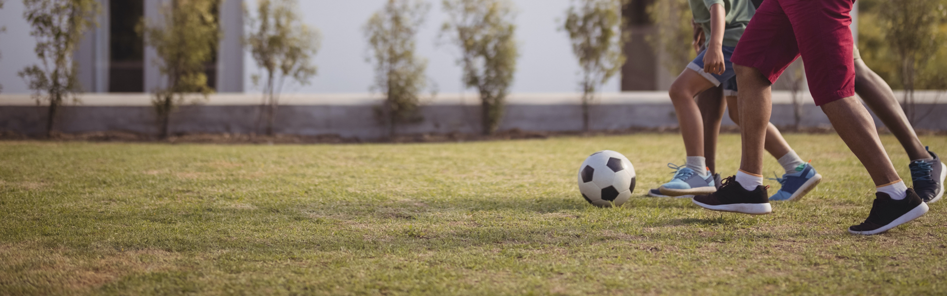 A group of people are playing soccer on a field.