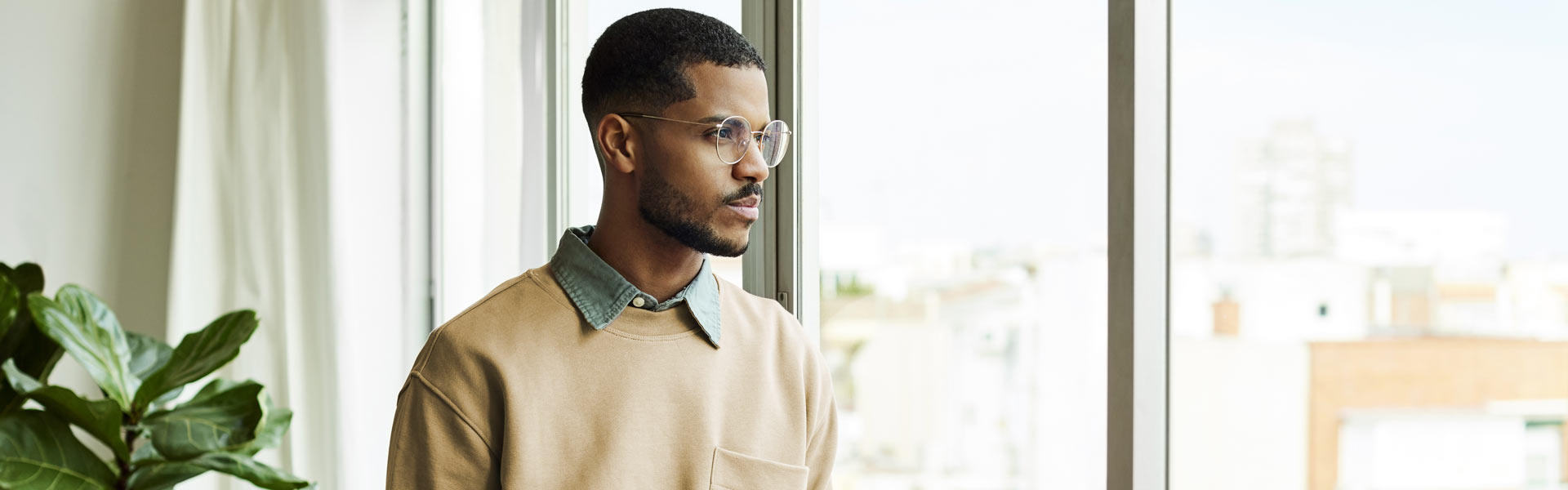 A young woman climbing the stairs, holding a laptop and smiling.