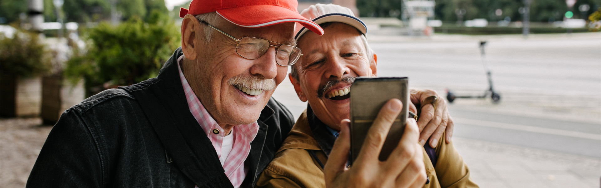 Two older men are smiling.