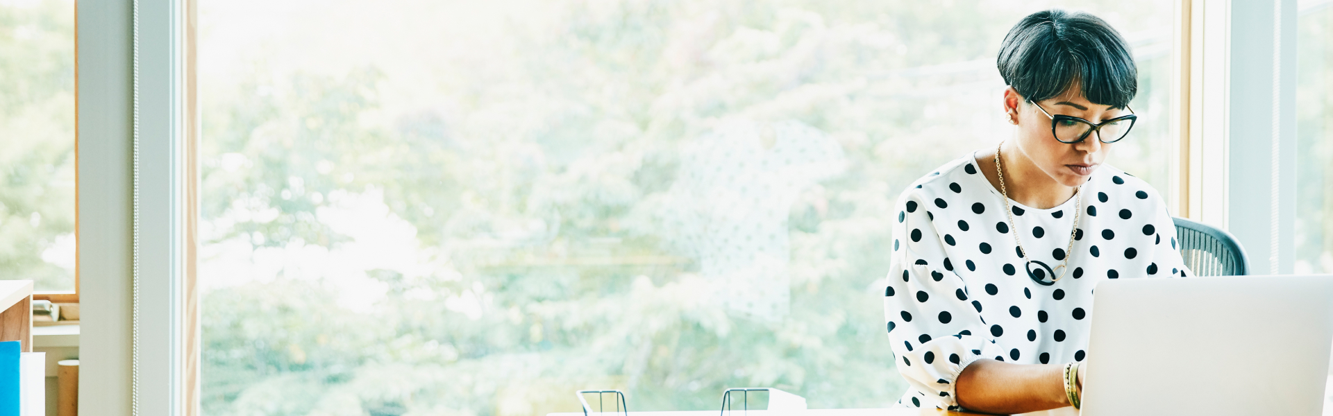 A woman is working on her laptop.