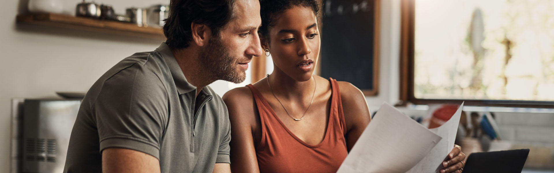 A man and woman are looking at documents.